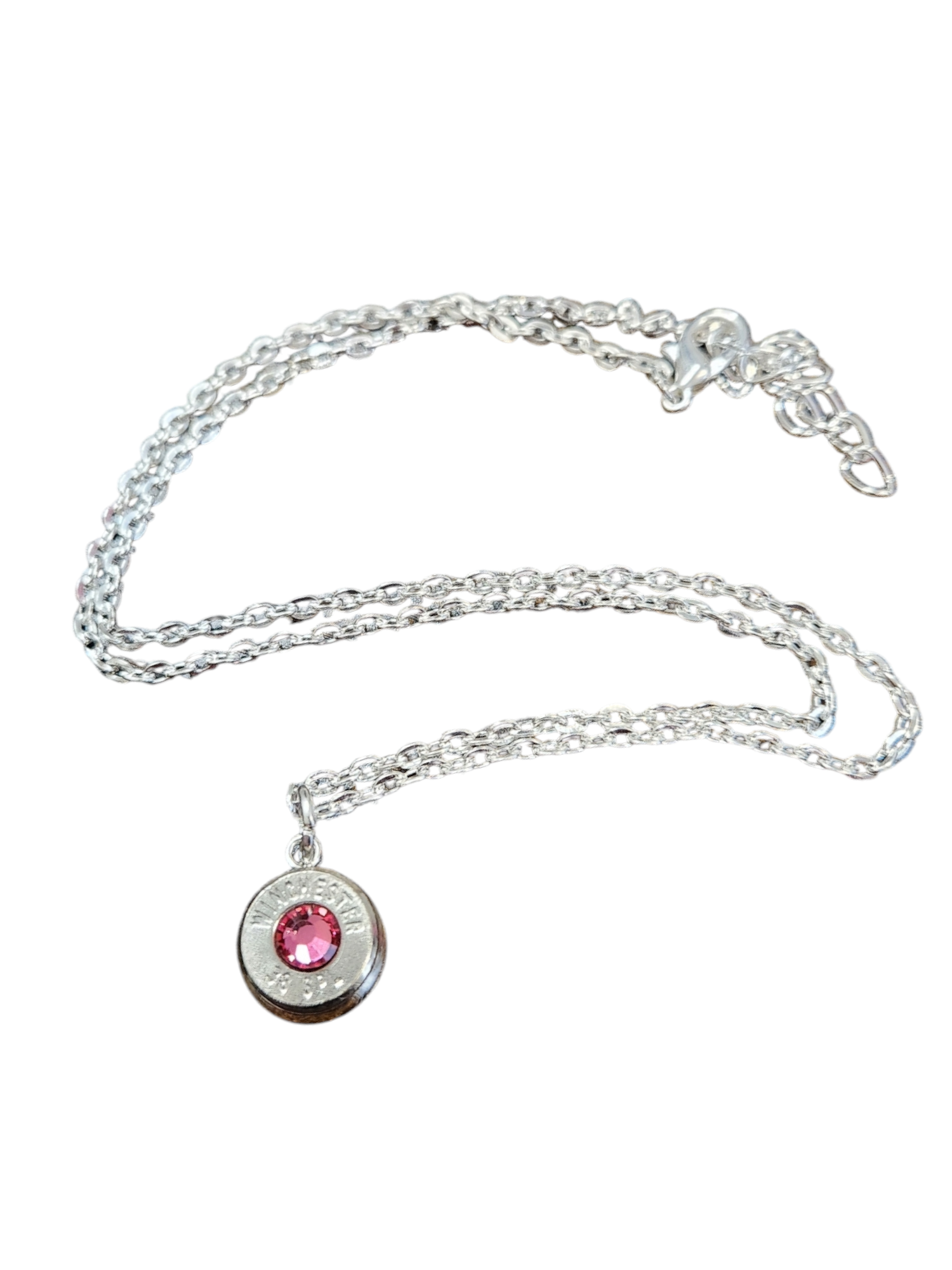 A silver-plated brass necklace with an adjustable chain and a round pendant featuring a crystal in the center, real headstamp, designed to be worn as a staple accessory.